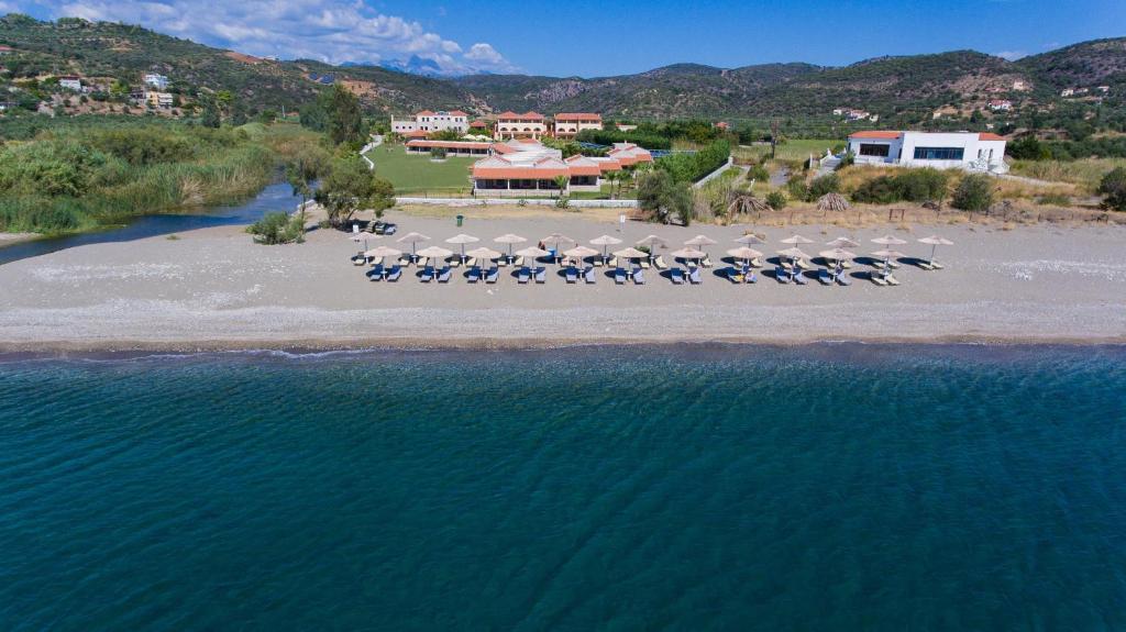 an aerial view of a beach with chairs and umbrellas at Aktaion Resort in Gythio