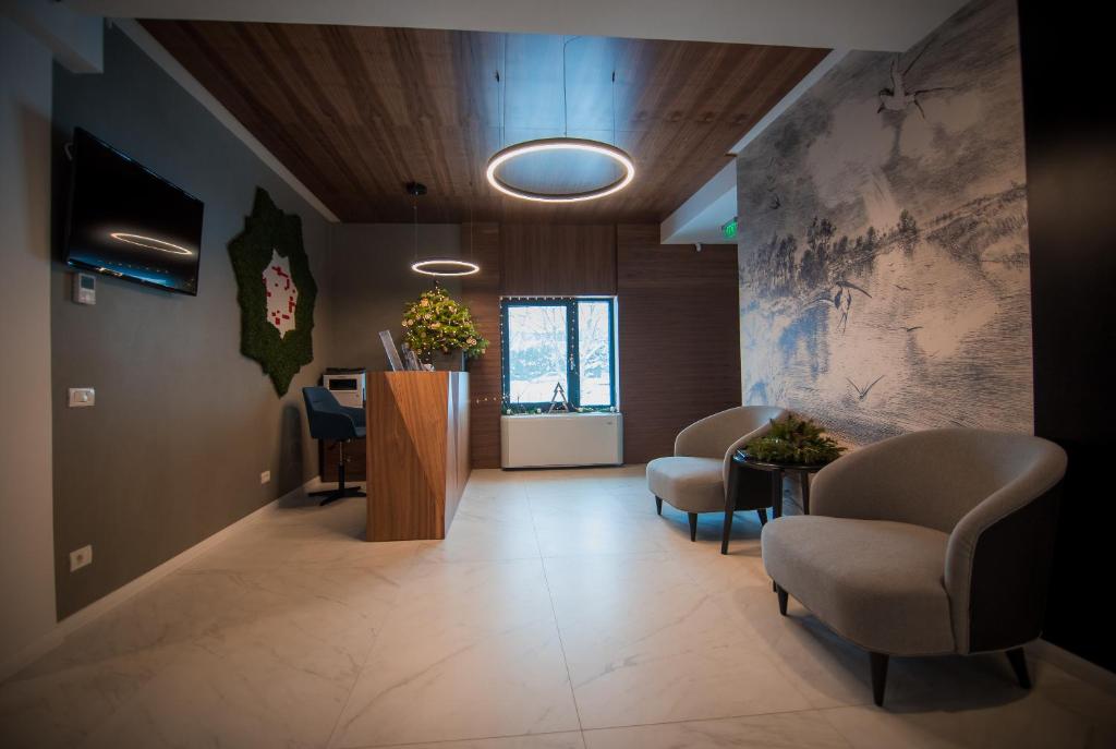 a waiting room with chairs and a reception desk at Element in Alba Iulia