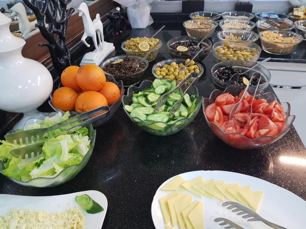 einen Tisch mit Schalen mit Obst und Gemüse in der Unterkunft Ismira Hotel Ankara in Ankara