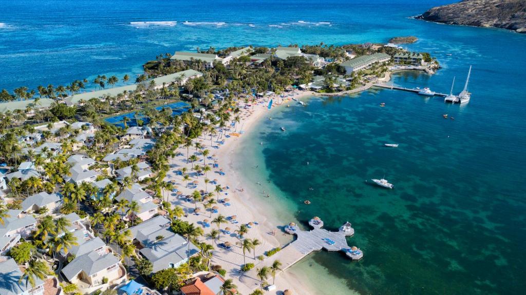 an aerial view of a beach with a crowd of people at St. James's Club Resort - All Inclusive in English Harbour Town