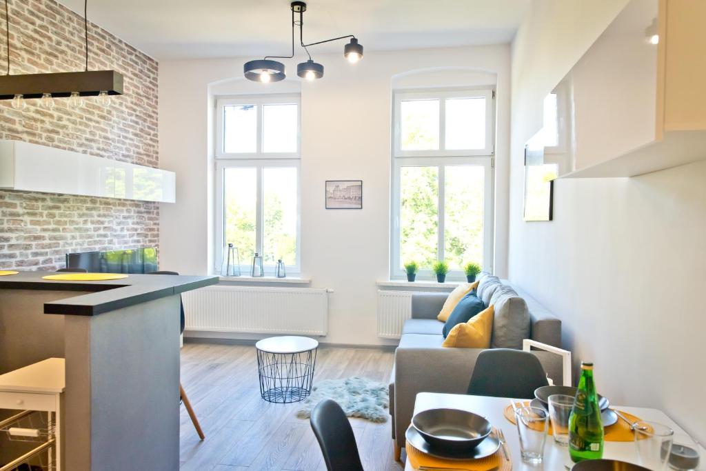 a living room with a couch and a table at Apartament Kalinka in Nysa