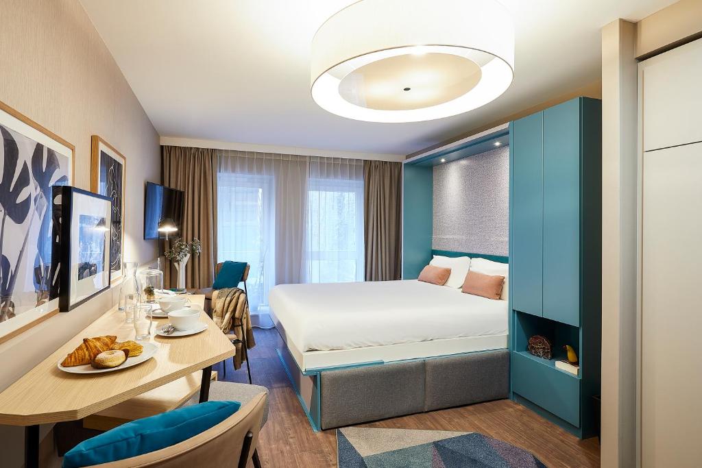 Säng eller sängar i ett rum på Aparthotel Adagio Lille Centre Grand Place