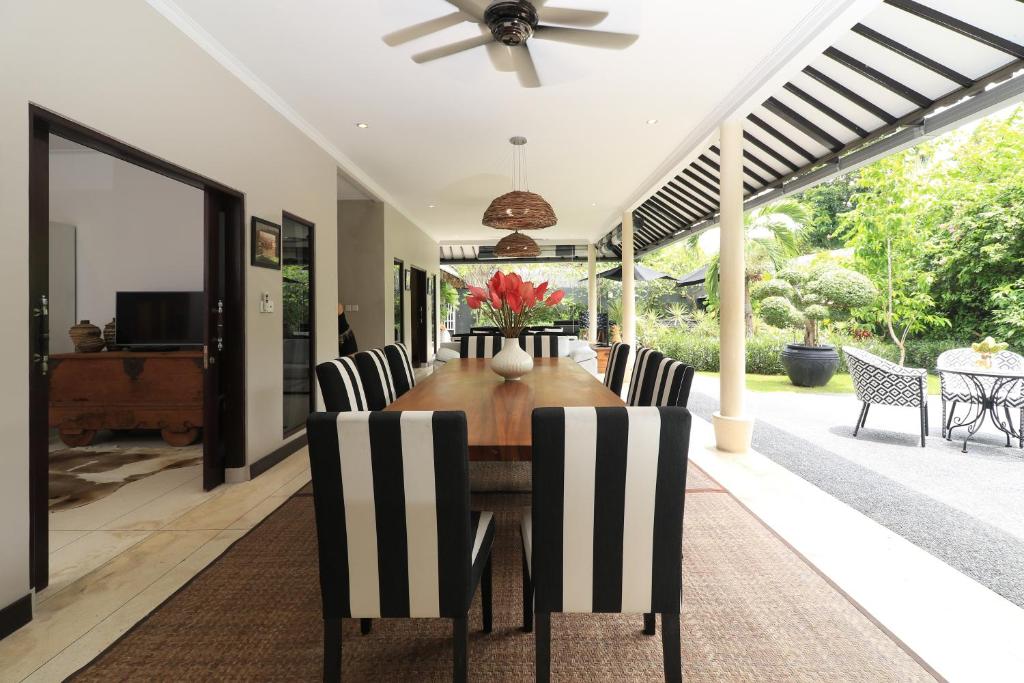 een eetkamer met een tafel en stoelen bij Villa Bloom 1 - 4 bedrooms, 4 bathrooms, private pool close to the beach in Seminyak