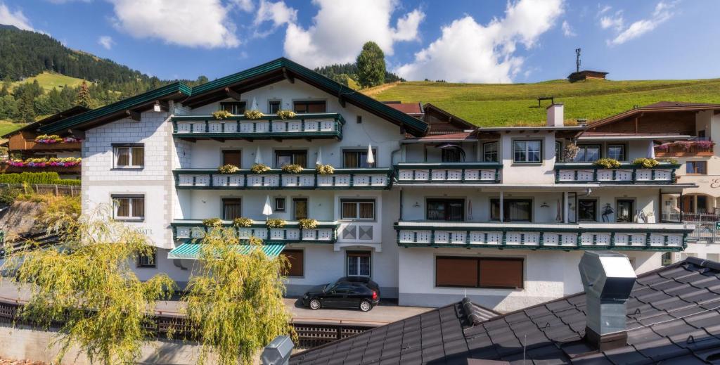 un grande edificio bianco con una verde collina sullo sfondo di Jennys Huamatl a Serfaus