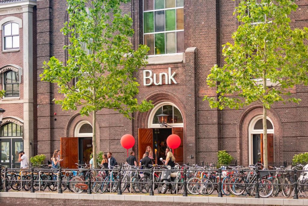 a brick building with a bunch of bikes parked in front at Bunk Hotel Utrecht in Utrecht