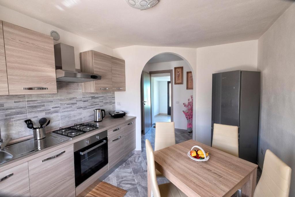 a kitchen with a table with a bowl of fruit on it at Casa delle rose in Verbania