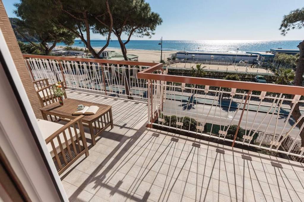 a balcony with a table and chairs and the beach at A casa di Monachella in Gaeta