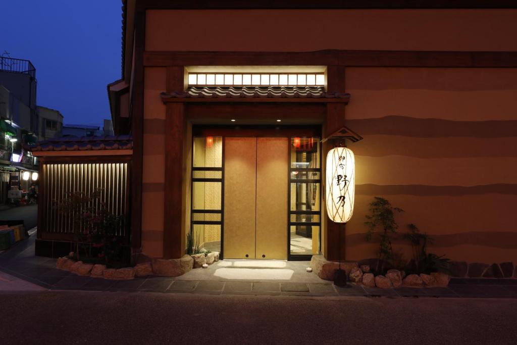 a front door of a building with a clock on it at Onyado Nono Asakusa Natural Hot Spring in Tokyo