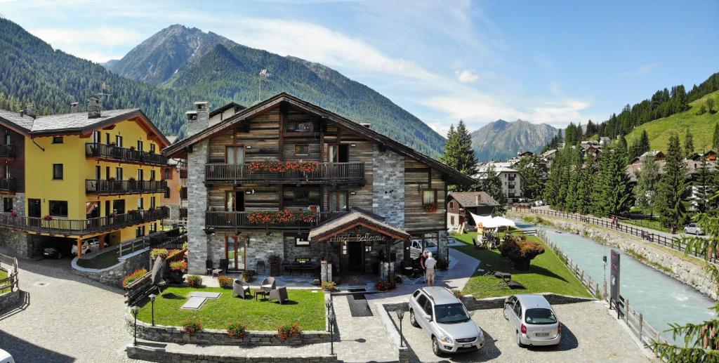 a building with cars parked in front of it at Hotel Bellevue in Champoluc