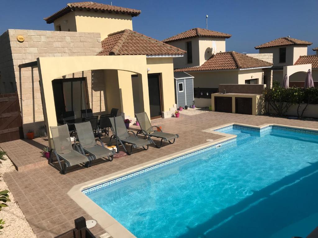 una piscina di fronte a una casa di Villa Kallista a Pissouri