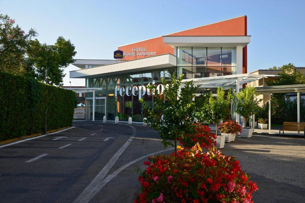 a shopping center with flowers in front of a building at Best Western Hotel Rome Airport in Fiumicino