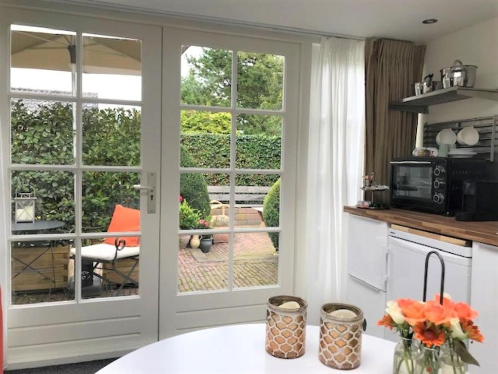 een keuken met een glazen schuifdeur naar een patio bij B&B Ereprijs in Den Haag