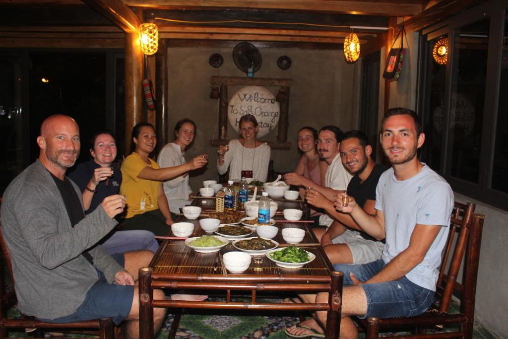 a group of people sitting around a table at Sapa Orange Homestay in Sa Pa