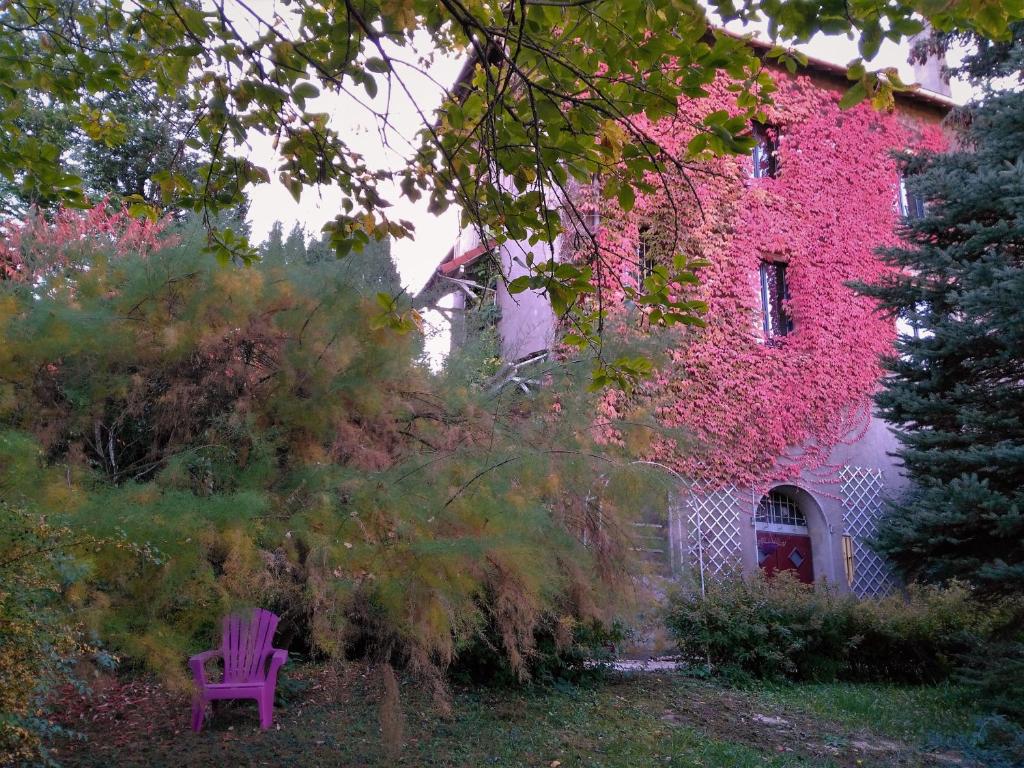 a purple chair sitting in front of a building at Villa Giselle in Hayange