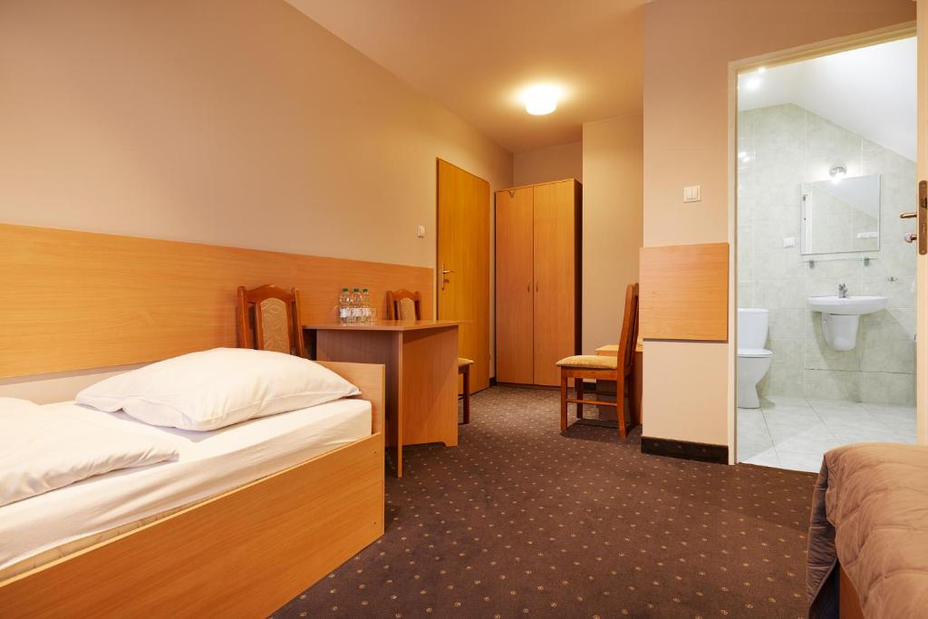 a hotel room with a bed and a bathroom at Hotel Wena in Kielce