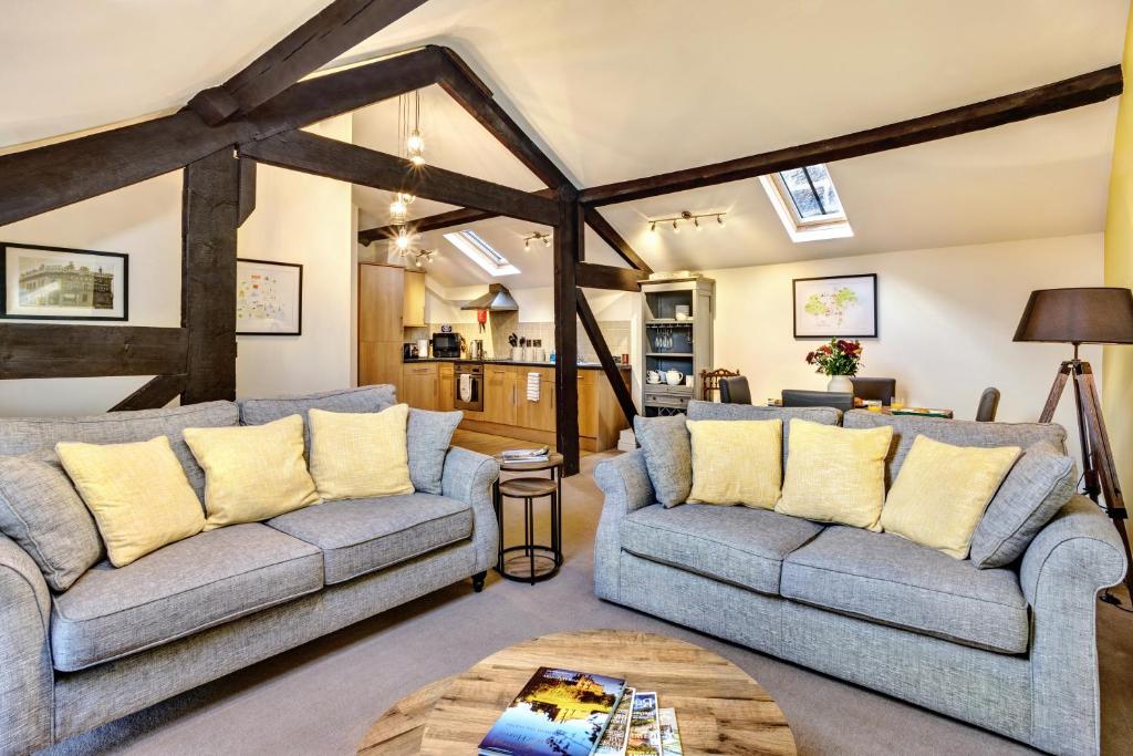 a living room with two couches and a table at The Old Sweet Factory in Harrogate