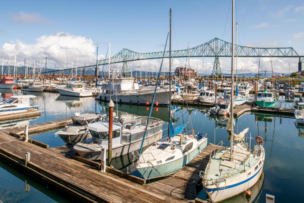 um grupo de barcos ancorados num porto com uma ponte em Astoria Riverwalk Inn em Astoria, Oregon