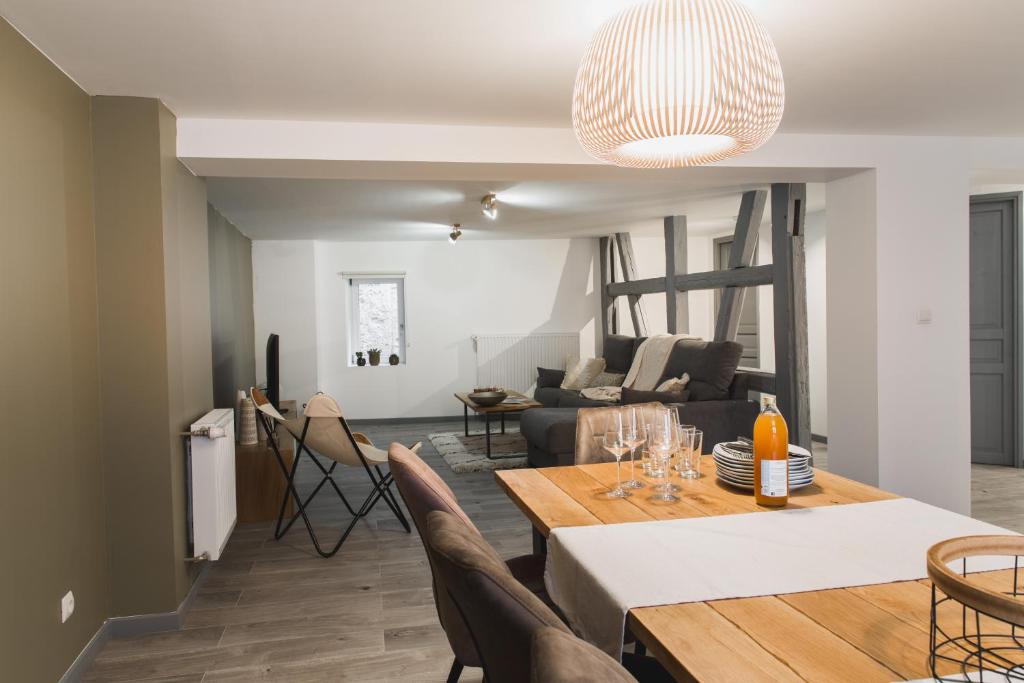 a dining room and living room with a table and chairs at Hissla Riquewihr Le Schlupf & La Perle in Riquewihr