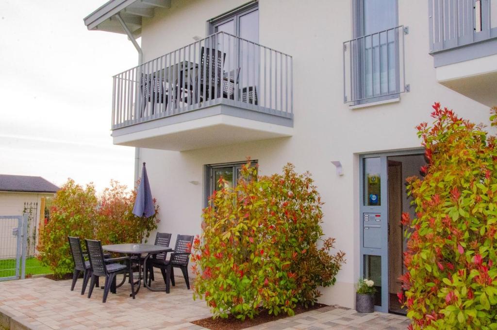 a patio with chairs and a table in front of a building at LaVaTe in Kappel-Grafenhausen