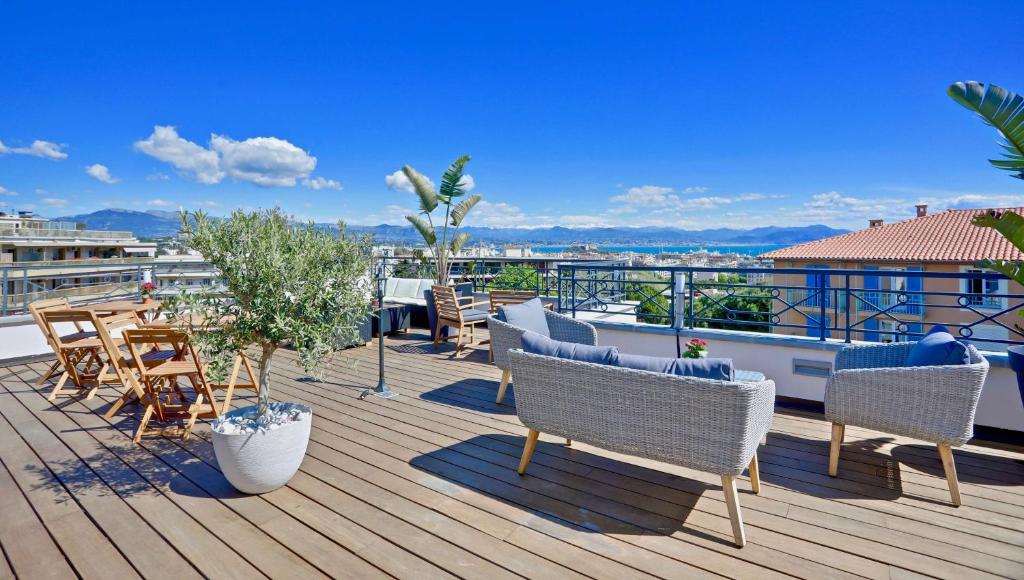 een terras met stoelen en tafels op een dak bij Best Western Hôtel Journel Antibes Juan-les-Pins in Antibes