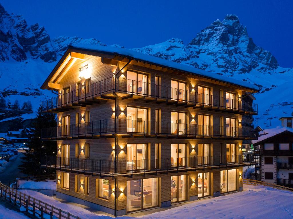 a building with a mountain in the background at Red Fox Lodge in Breuil-Cervinia