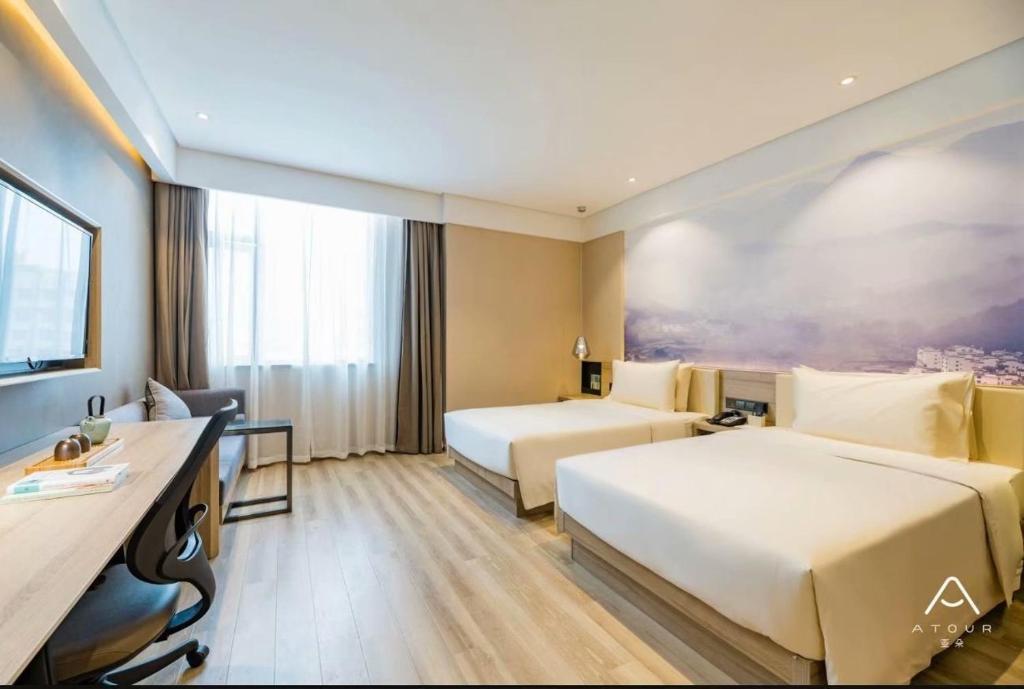 Cama ou camas em um quarto em Atour Hotel Tianjin Zhongxin Eco-City