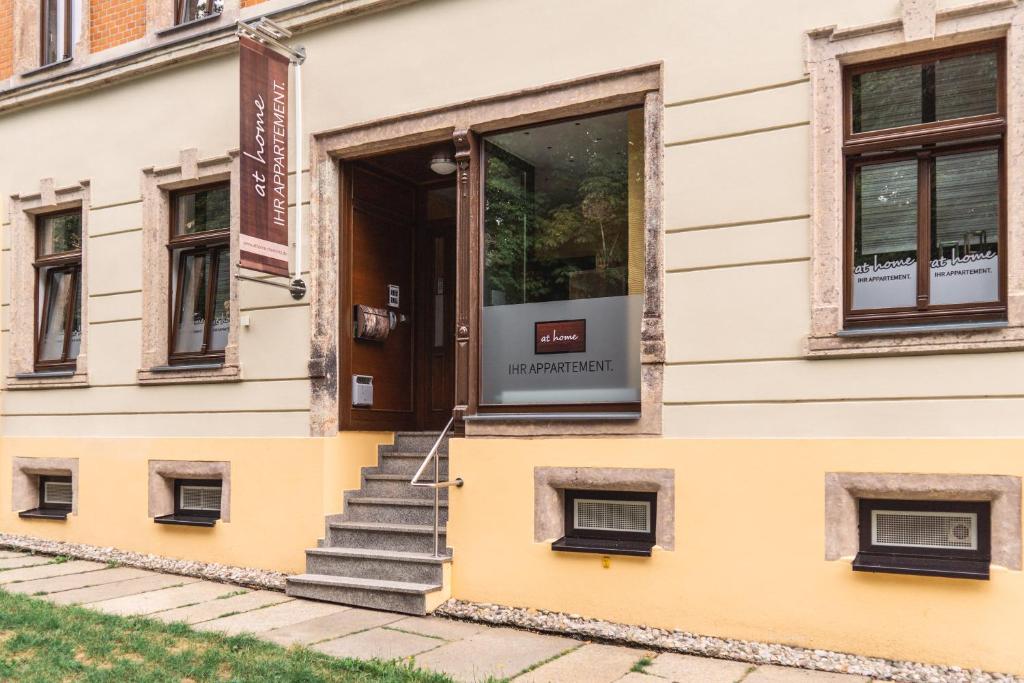 a door on the side of a building with stairs at athome IHR Apartment in Chemnitz