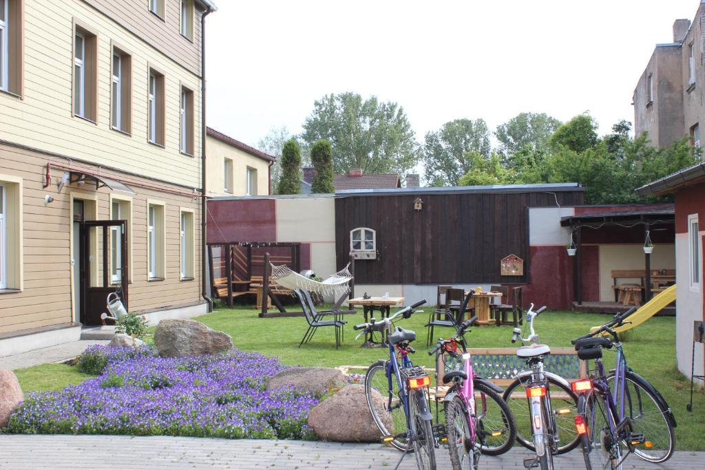 a group of bikes parked in a yard at Windrose in Liepāja