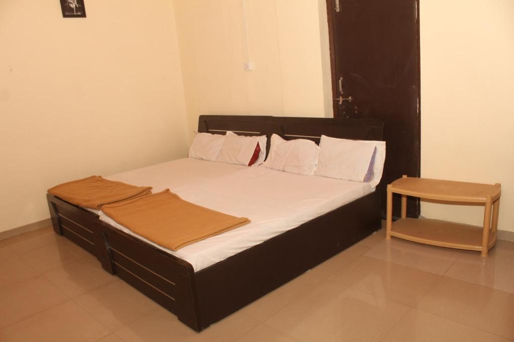 A bed or beds in a room at Hotel Sai Satya