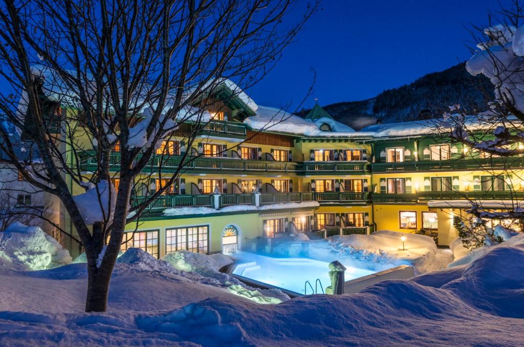 a hotel in the snow at night at Hotel Sommerhof in Gosau