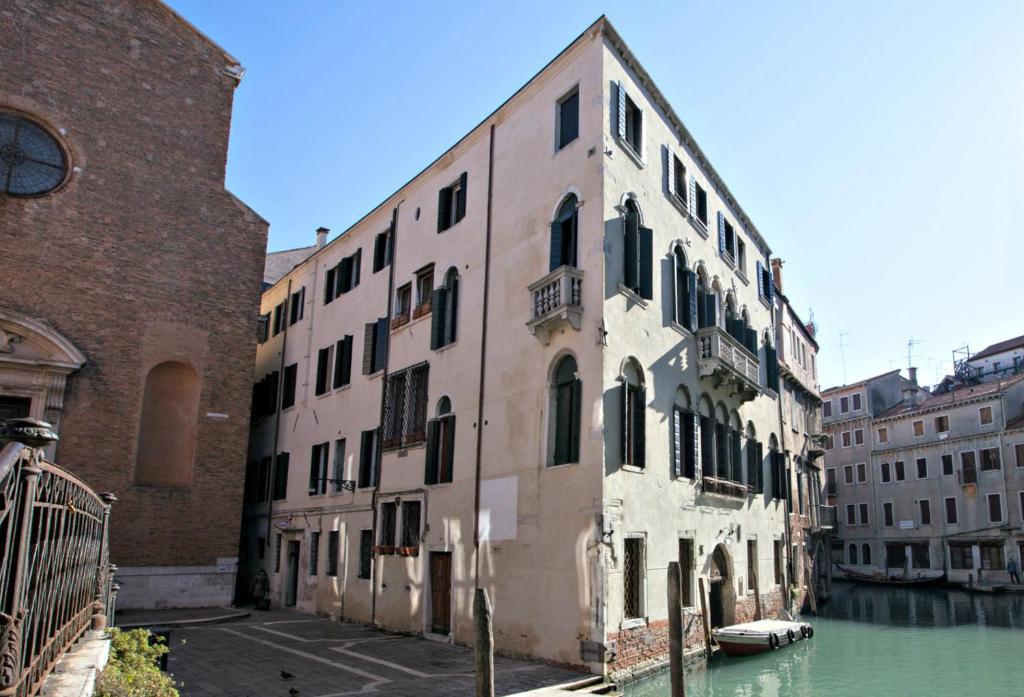 an old building sitting next to a canal at Residence Ca' Foscolo in Venice