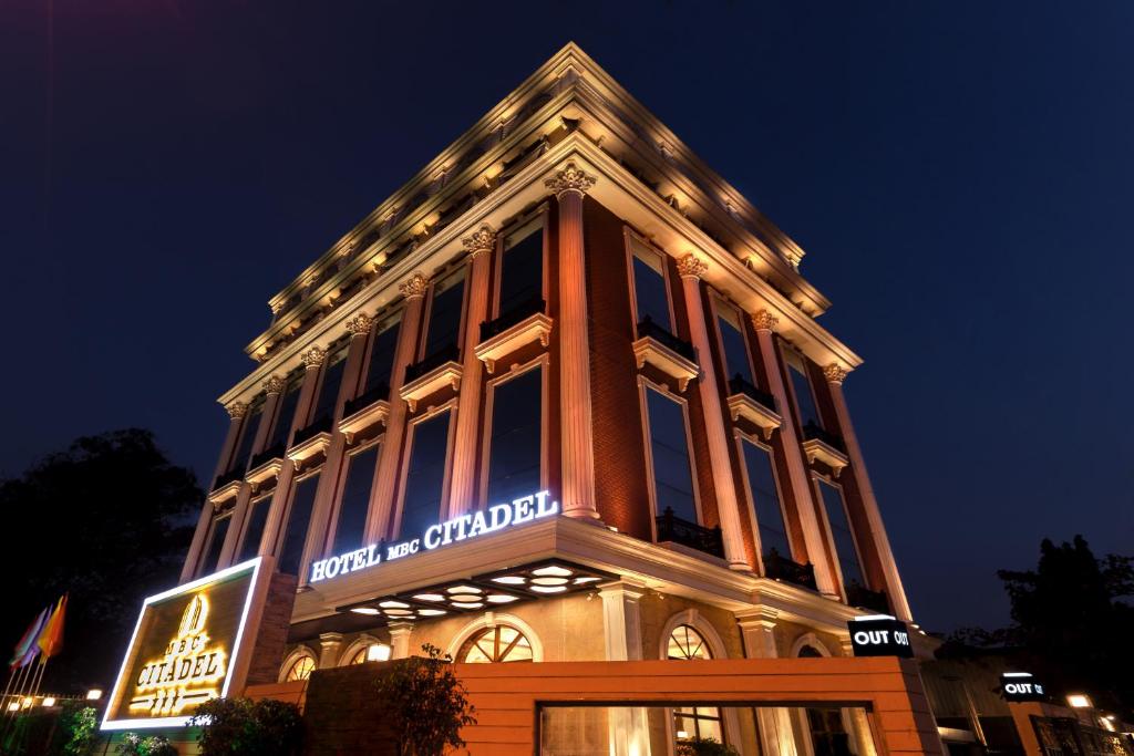 a building with a sign on the side of it at Hotel MBC Citadel Nashik in Nashik