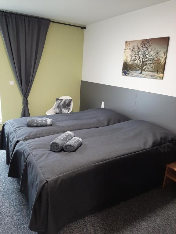 a bedroom with a bed with two stuffed animals on it at Office Base Bad Vöslau MOTEL in Bad Vöslau