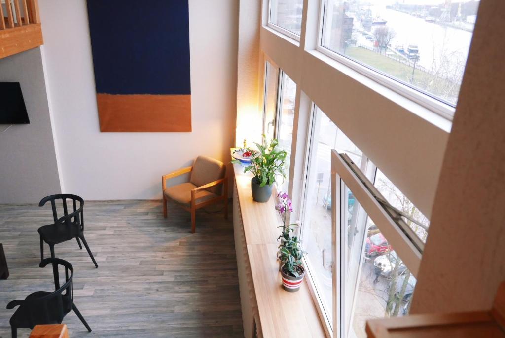 a room with a window and a table and chairs at Artists Residence Liepāja in Liepāja