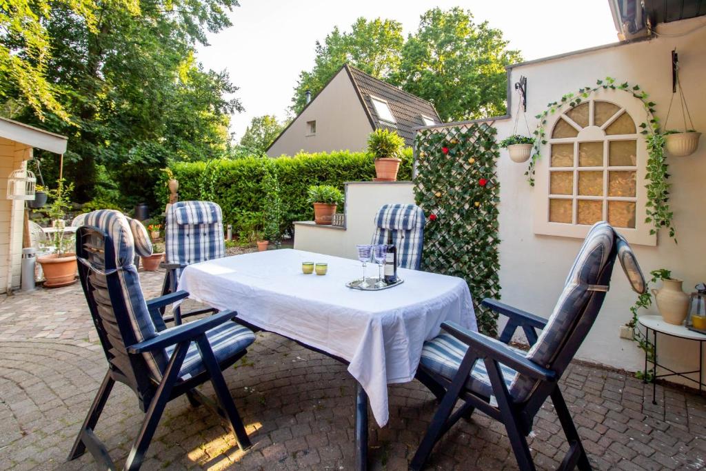 a table and four chairs on a patio at Casita Boschberg in Biddinghuizen