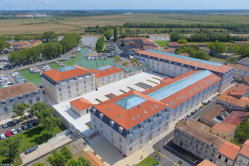 an overhead view of a large building with orange roofs at Résidence de l'Arsenal Royal - Meublés de Tourisme in Rochefort