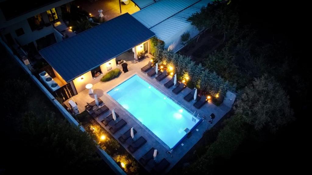 an overhead view of a swimming pool at night at Pensiunea Nora Prestige in Timişoara