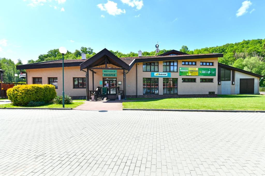 a building with a brick driveway in front of it at Pension Tenis - Centrum in Český Krumlov