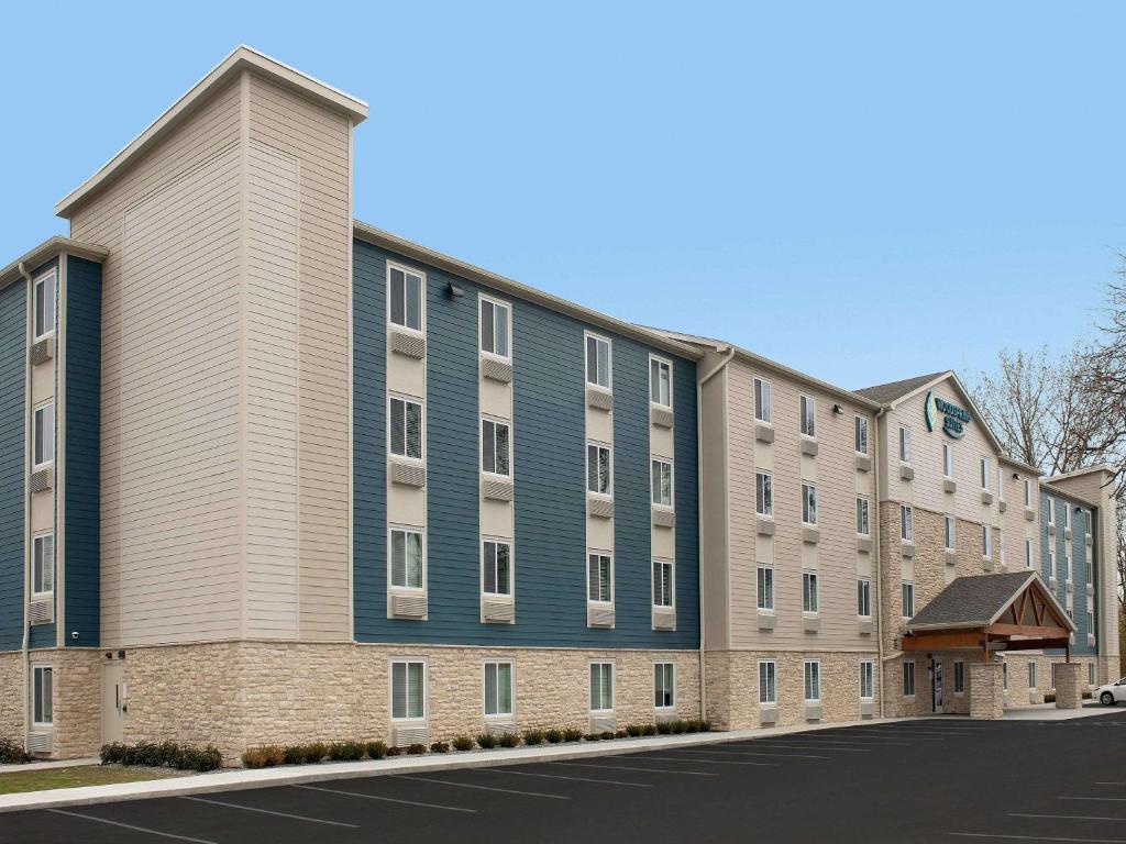 ein Apartmenthaus mit einem blauen und weißen Gebäude in der Unterkunft WoodSpring Suites Merrillville in Merrillville