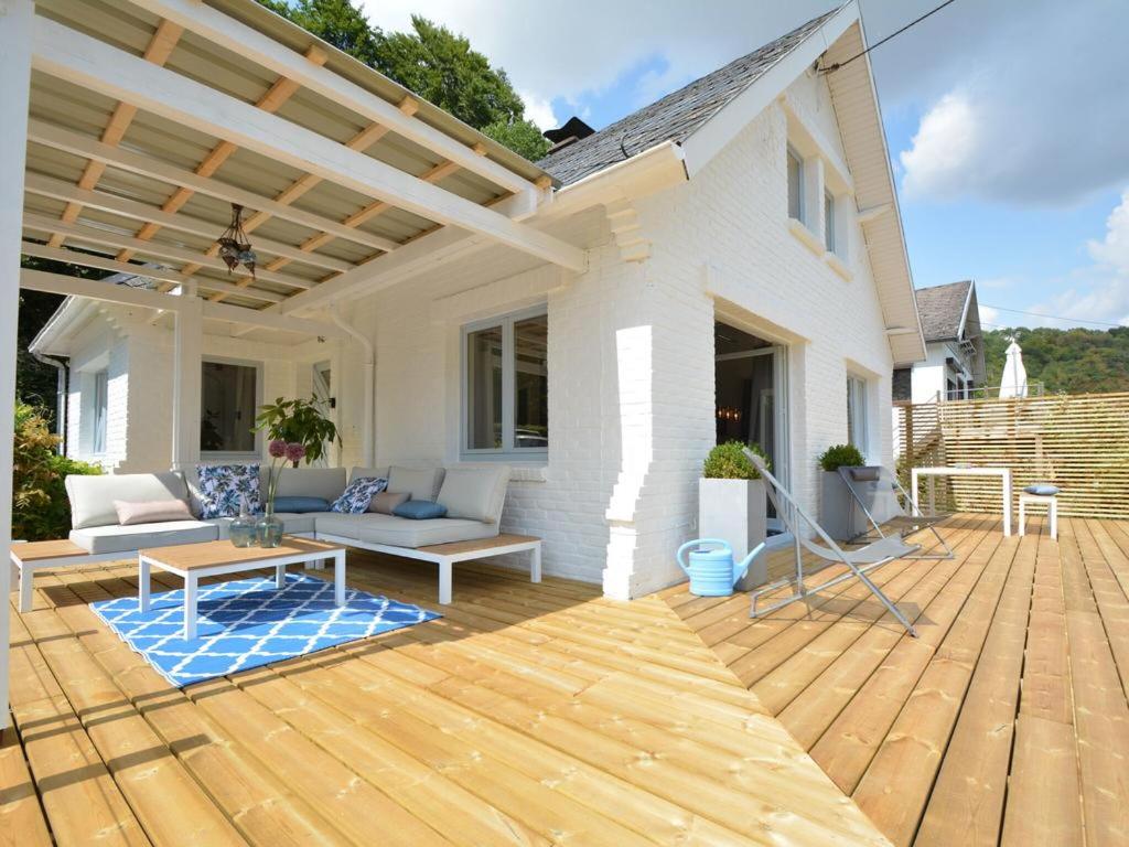 a patio with a wooden deck with a pergola at Villa Waulsort in Waulsort