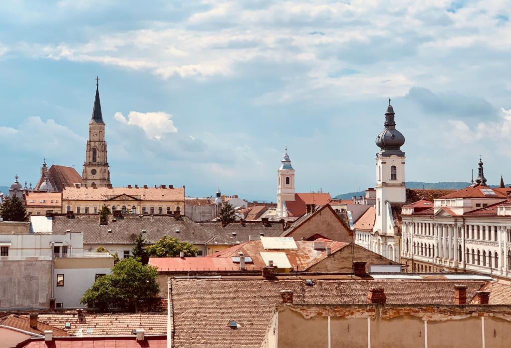 a view of a city with buildings and churches at Hotel Victoria in Cluj-Napoca