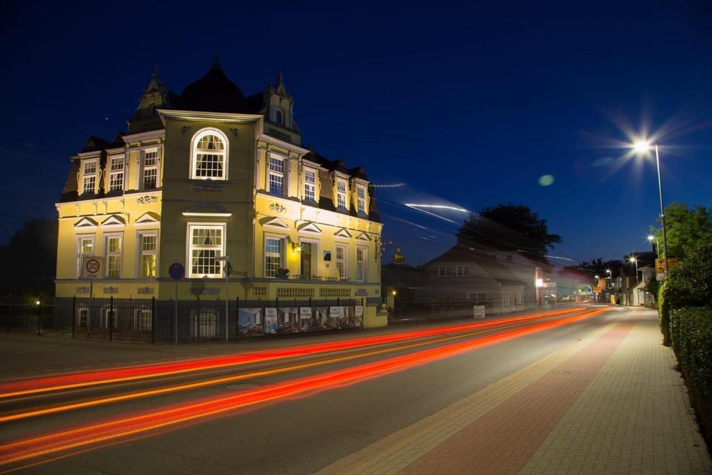 un edificio en una calle por la noche con rayas de luces en Hotel Villa Schneverdingen, en Schneverdingen