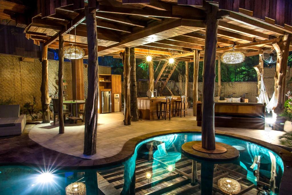 a pool in the middle of a room with a table at Gili Treehouse in Gili Trawangan