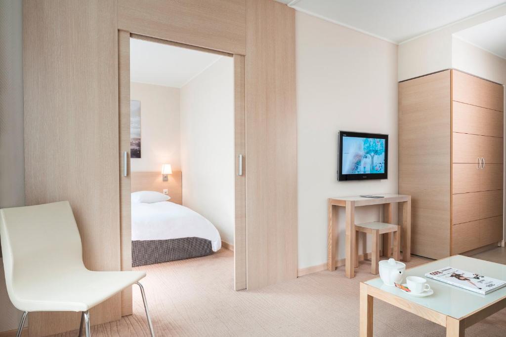 Cama ou camas em um quarto em Starling Hôtel Résidence Genève