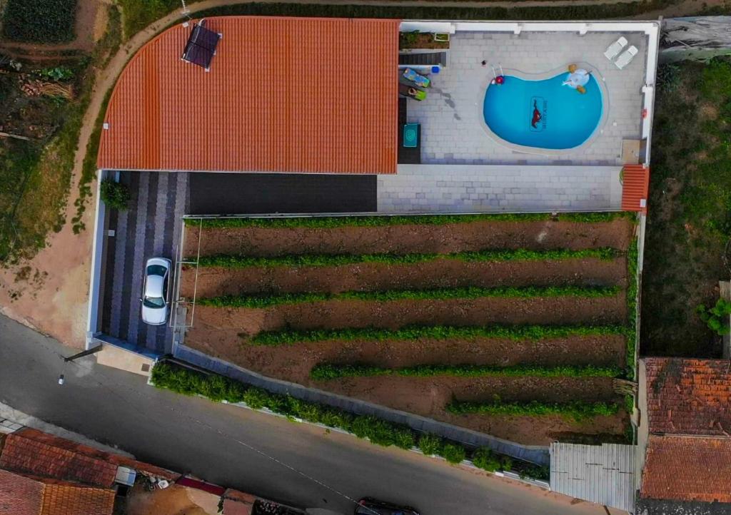 an overhead view of a farm with a field of crops at Casinha das Bonecas - Casa com Piscina Privada in Aveiro