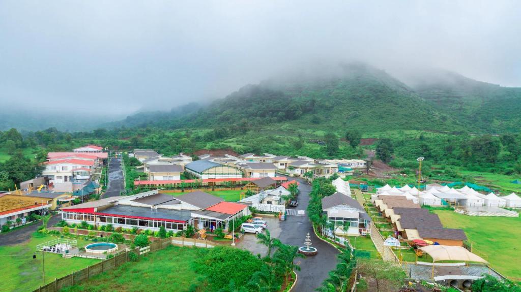 an aerial view of a village with a mountain at Rainforest Resort and Spa, Igatpuri -Nature's Luxury Awaits in Igatpuri