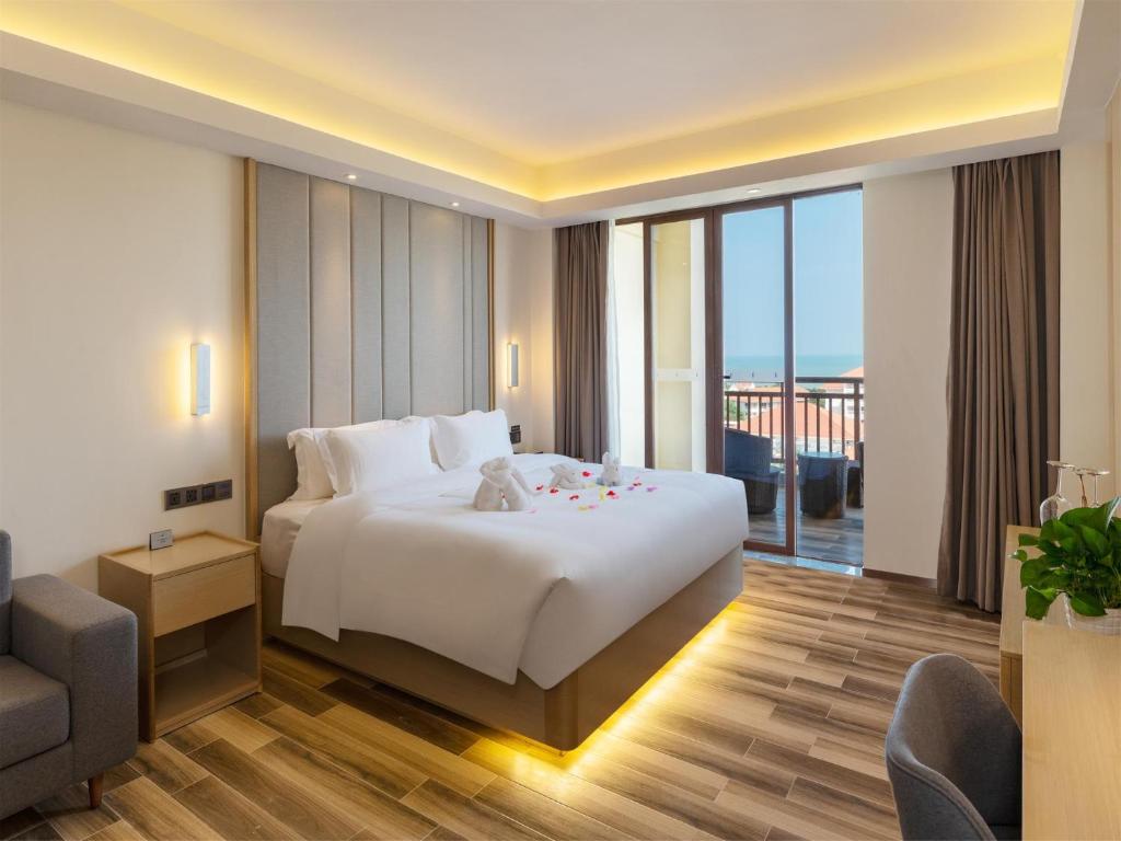 Säng eller sängar i ett rum på Lavande Hotel Haikou Binhai Avenue