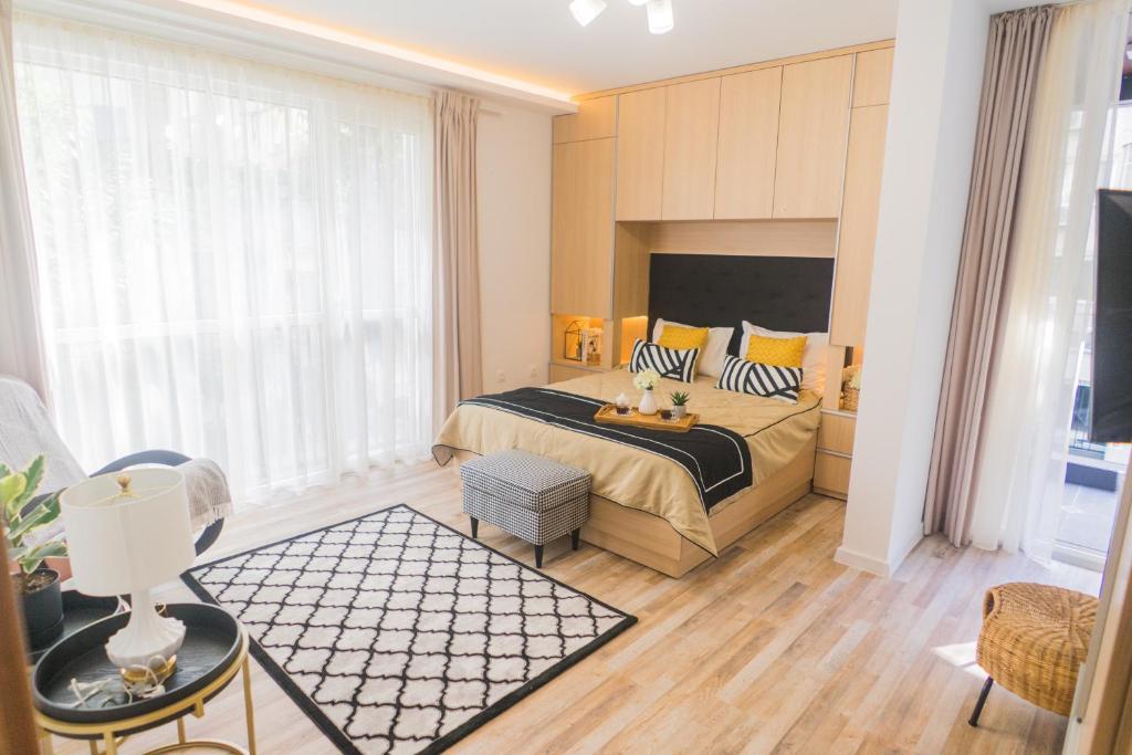 a bedroom with a bed and a large window at Sevastopol apartments Varna in Varna City