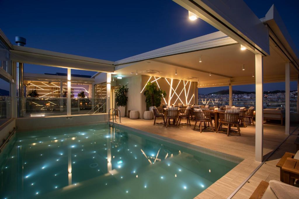 a house with a swimming pool at night at Green Suites Boutique Hotel in Athens