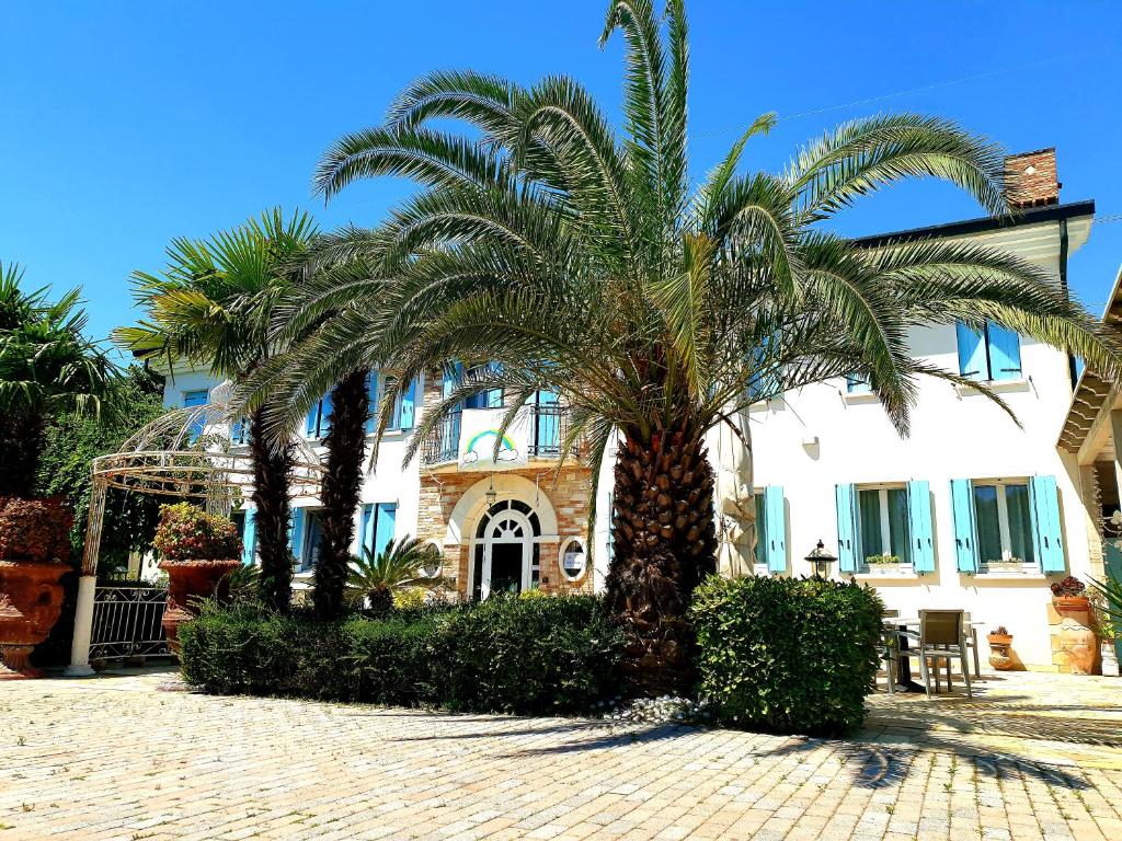 una palmera frente a un edificio en Agriturismo Dolceacqua, en Cavallino-Treporti